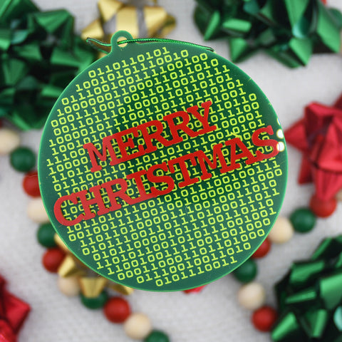 Green Christmas ornament with red text 'Merry Christmas' on a festive background