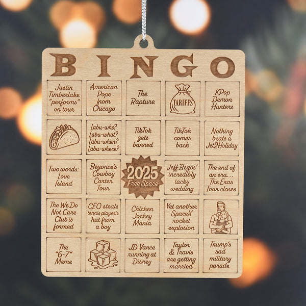 Wooden bingo board with humorous 2025 events on a blurred background
