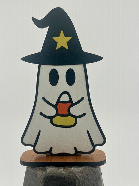 Halloween-themed ghost figurine with a witch hat and candy corn on a white background