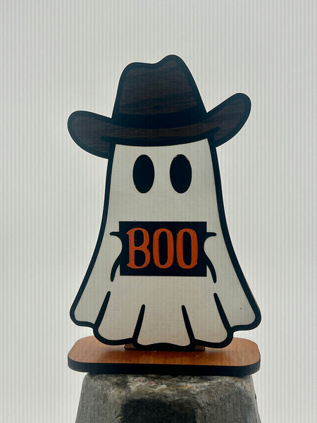 Ghost figurine with a cowboy hat and 'BOO' sign on a gray background