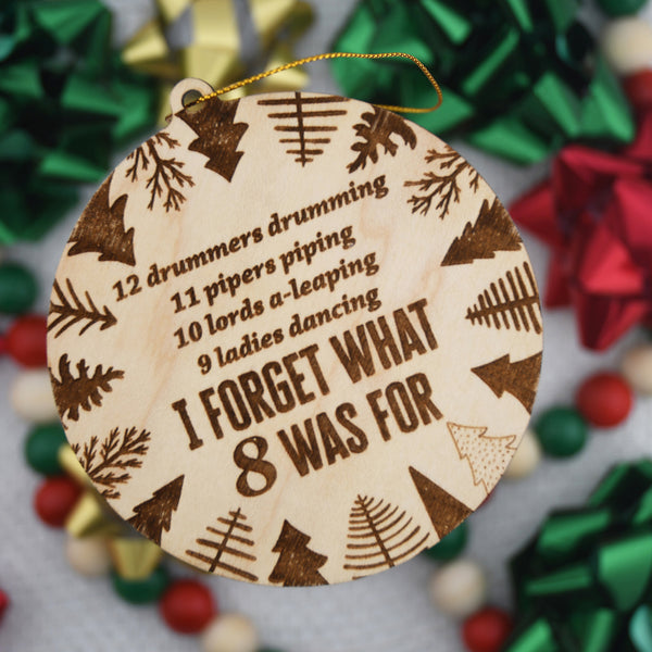 Wooden ornament with Christmas-themed text and patterns on a festive background