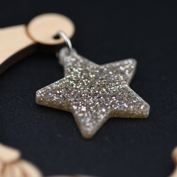 Star-shaped glittery ornament on a dark background